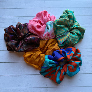 Colorful scrunchies on a light wooden surface